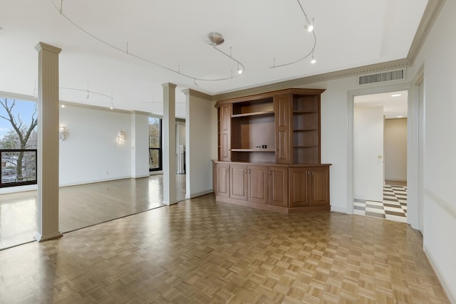 unfurnished living room featuring decorative columns, light parquet flooring, and ornamental molding