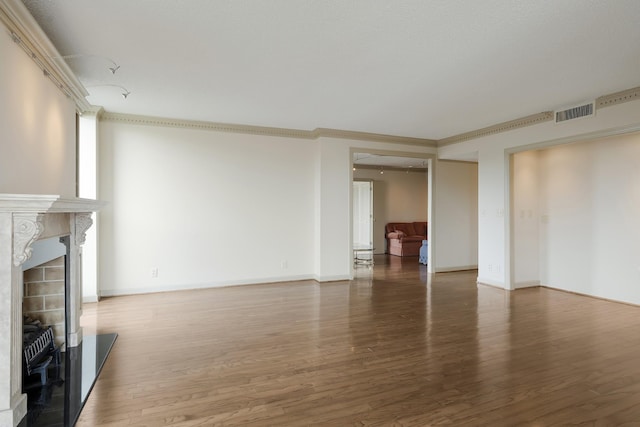 unfurnished living room featuring dark hardwood / wood-style floors and crown molding