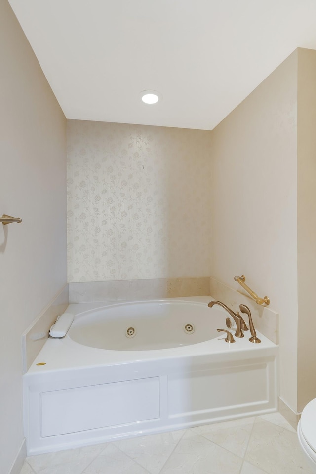 bathroom featuring tile patterned floors, toilet, and a bathing tub