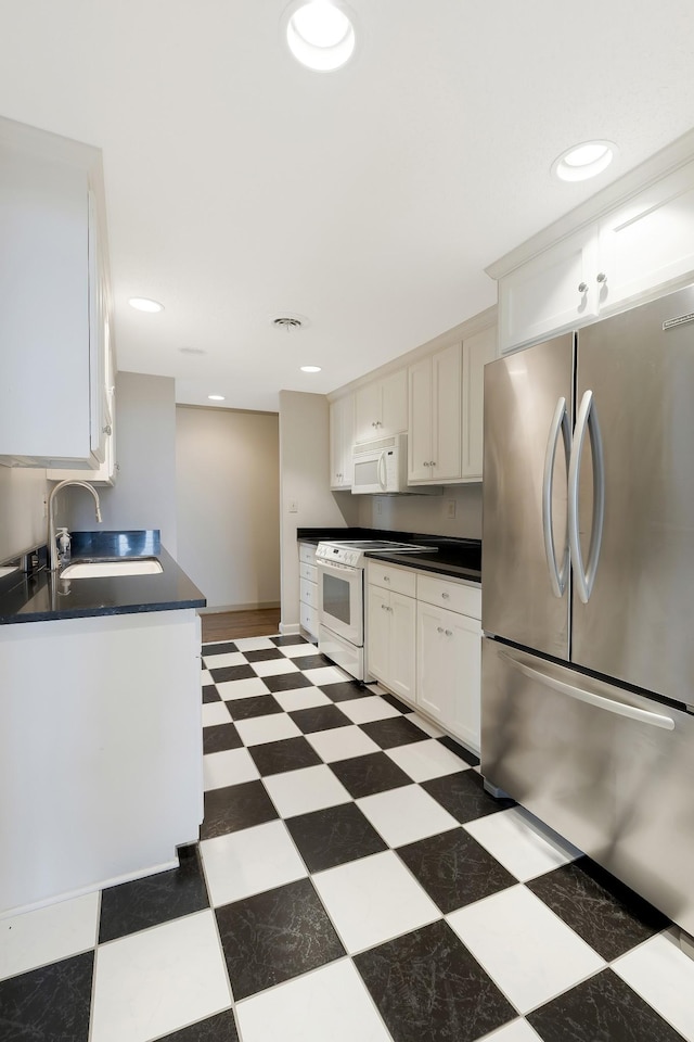 kitchen featuring white cabinets, white appliances, and sink