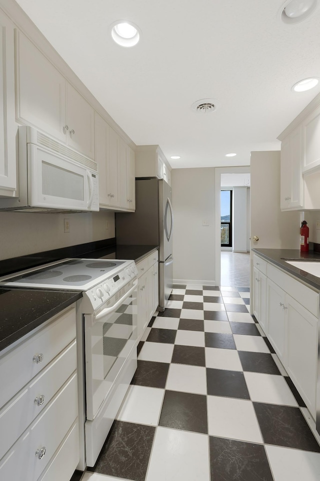 kitchen with sink, white cabinets, and white appliances