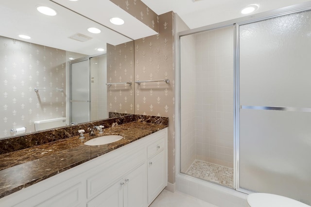 bathroom featuring vanity and a shower with shower door