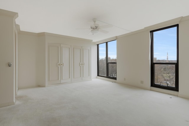 unfurnished bedroom featuring light colored carpet and ceiling fan