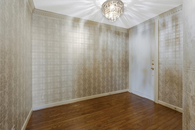 spare room with hardwood / wood-style flooring, a textured ceiling, and an inviting chandelier