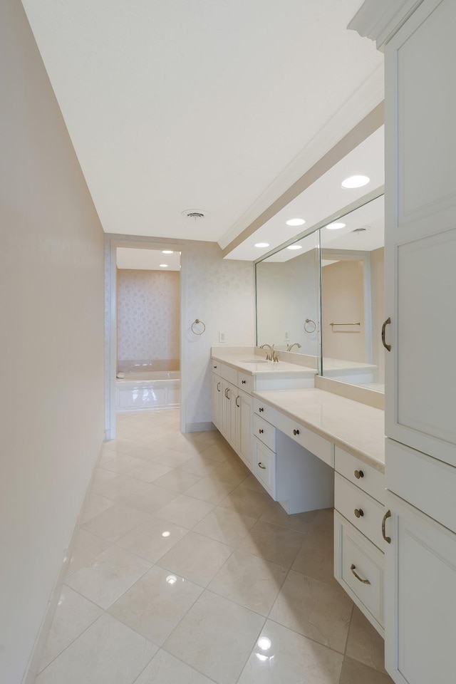 bathroom featuring tile patterned flooring, vanity, and a relaxing tiled tub