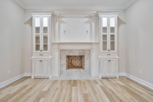 unfurnished living room featuring a fireplace, light hardwood / wood-style floors, and a healthy amount of sunlight