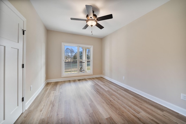 spare room featuring light hardwood / wood-style floors and ceiling fan