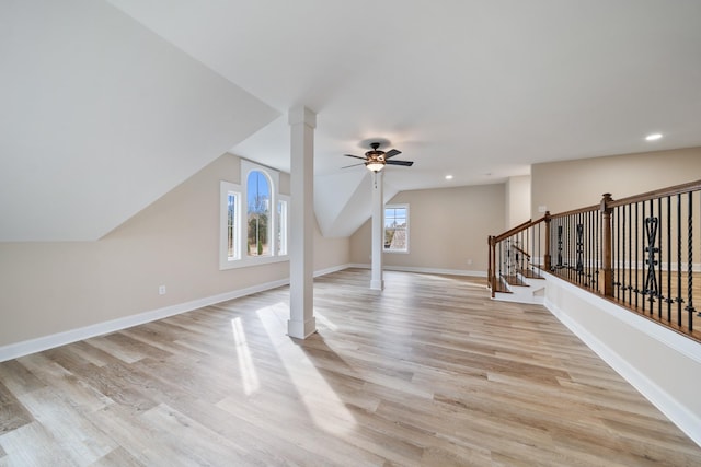 additional living space featuring ceiling fan, light wood-type flooring, a wealth of natural light, and lofted ceiling