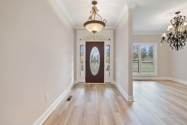 foyer featuring crown molding, light hardwood / wood-style floors, and a notable chandelier