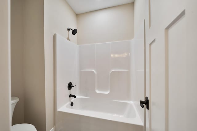 bathroom featuring bathing tub / shower combination and toilet