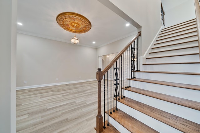 stairway featuring wood-type flooring and ornamental molding