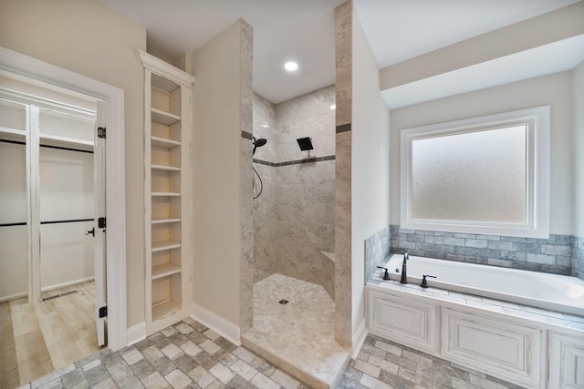 bathroom with wood-type flooring and plus walk in shower