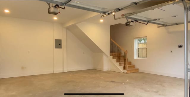 garage with electric panel and a garage door opener