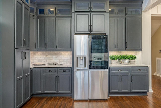 kitchen featuring stainless steel fridge, dark hardwood / wood-style flooring, and backsplash