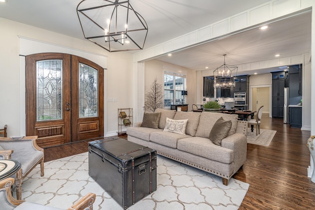 living room featuring a chandelier, french doors, and hardwood / wood-style flooring