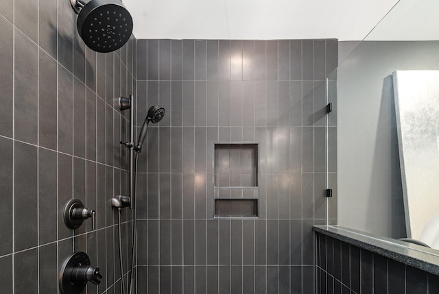 bathroom with a tile shower