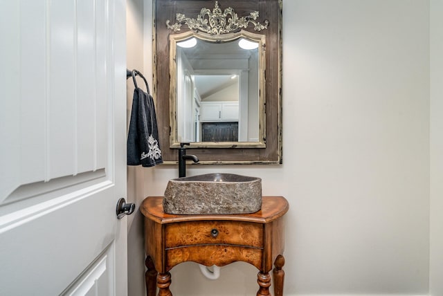 bathroom with vanity and a chandelier