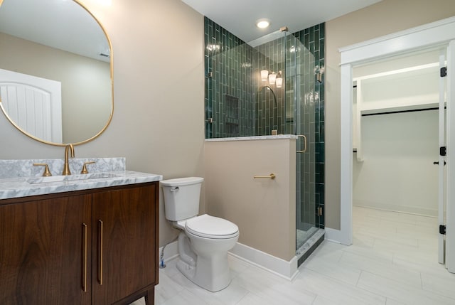 bathroom with tile patterned flooring, vanity, toilet, and a shower with shower door