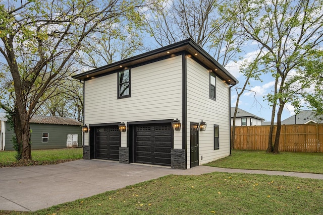 view of side of home featuring a lawn and a garage