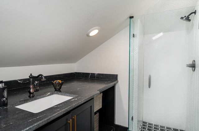 bathroom with a shower, vanity, and lofted ceiling