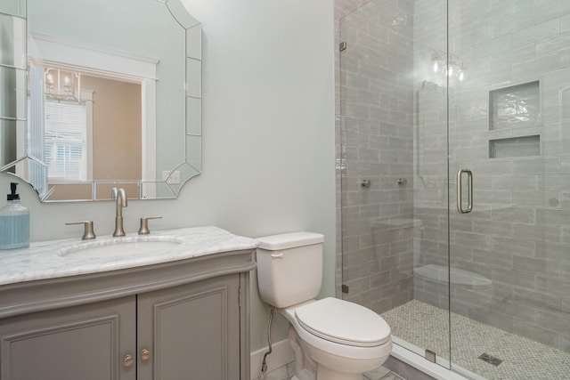 bathroom with vanity, toilet, and walk in shower