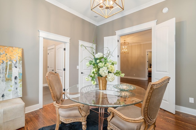 dining room with dark hardwood / wood-style flooring, an inviting chandelier, and crown molding