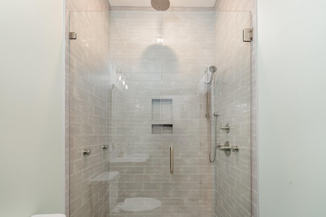 bathroom featuring toilet and walk in shower