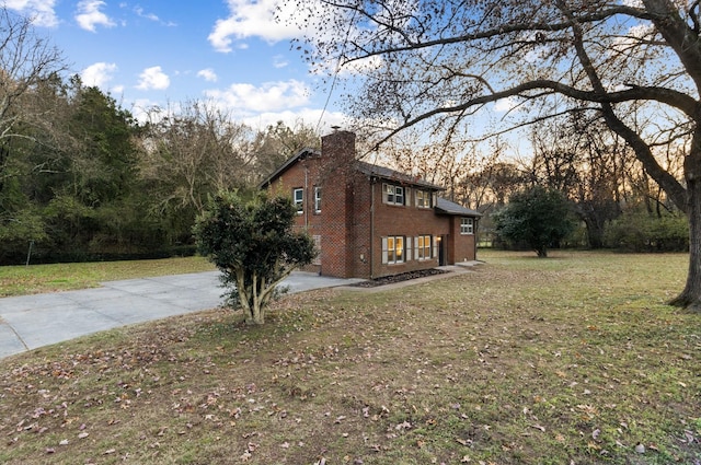 view of property exterior with a lawn