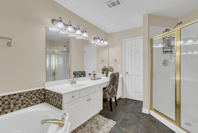 bathroom with vanity and independent shower and bath