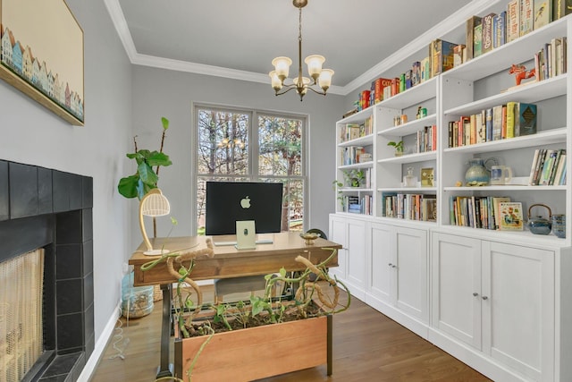 office featuring dark hardwood / wood-style floors, ornamental molding, a fireplace, and a chandelier