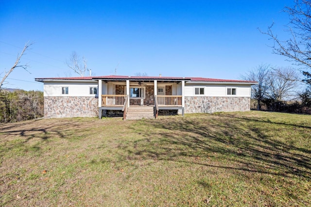 back of house featuring a yard and covered porch