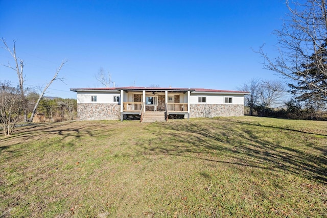 rear view of house with a lawn and covered porch