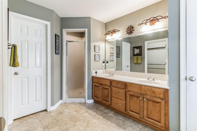 bathroom with vanity and a shower with shower door