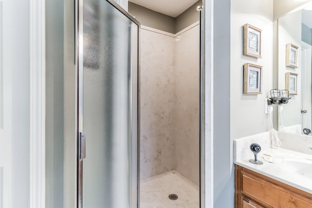 bathroom with vanity and a shower with shower door