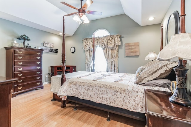 bedroom with ceiling fan, light hardwood / wood-style flooring, and vaulted ceiling