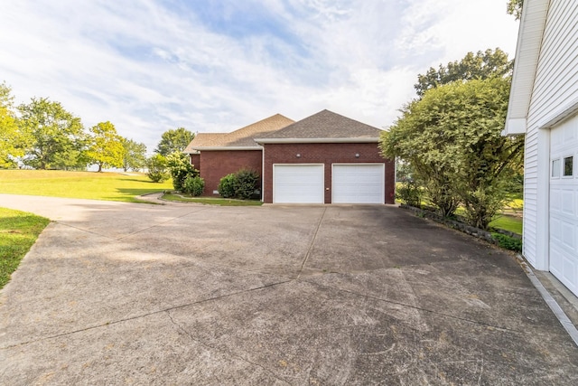 view of home's exterior with a yard and a garage