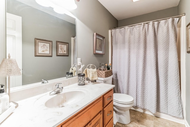 bathroom featuring tile patterned flooring, vanity, and toilet