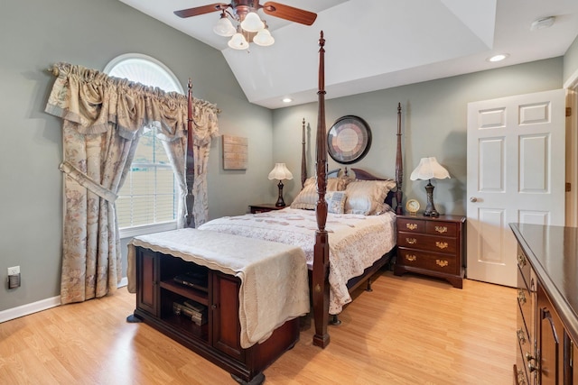 bedroom with light wood-type flooring, vaulted ceiling, and ceiling fan