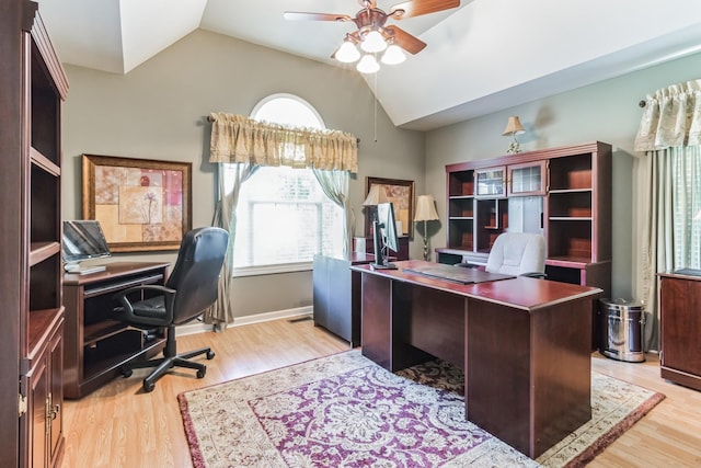 office area with a healthy amount of sunlight, vaulted ceiling, and light wood-type flooring