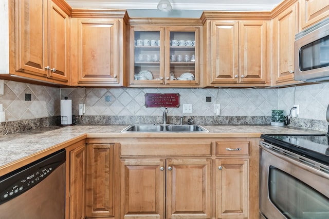 kitchen featuring stainless steel appliances, tasteful backsplash, crown molding, and sink