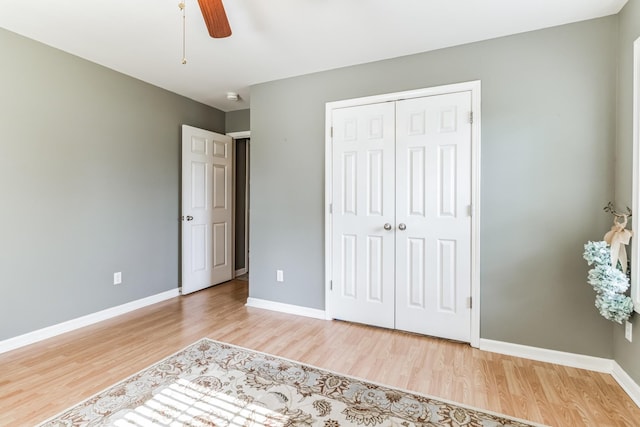 unfurnished bedroom featuring ceiling fan, a closet, and light hardwood / wood-style floors