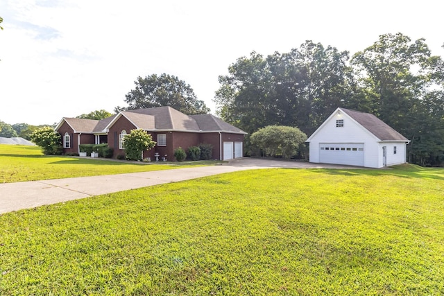 view of front of home featuring an outbuilding, a garage, and a front yard