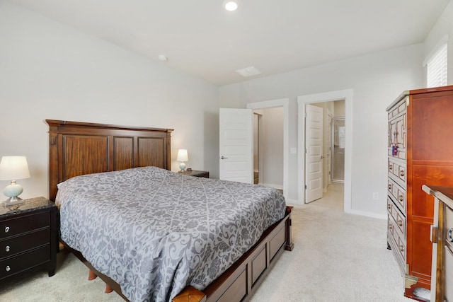 bedroom featuring light carpet and ensuite bath