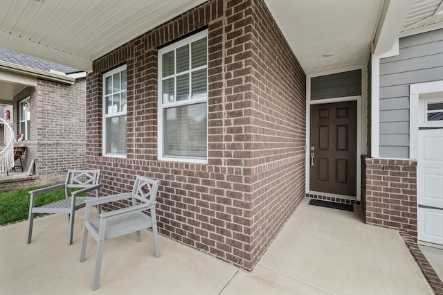 view of exterior entry featuring a porch