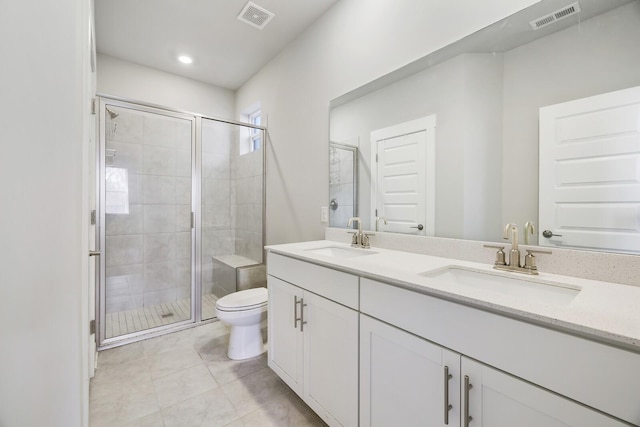 bathroom featuring an enclosed shower, vanity, toilet, and tile patterned flooring