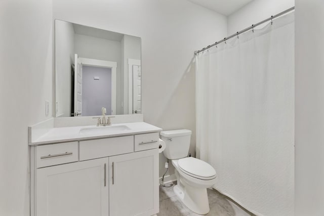 bathroom with toilet, vanity, and tile patterned flooring