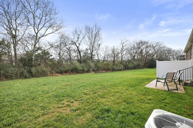 view of yard with a patio and central AC unit