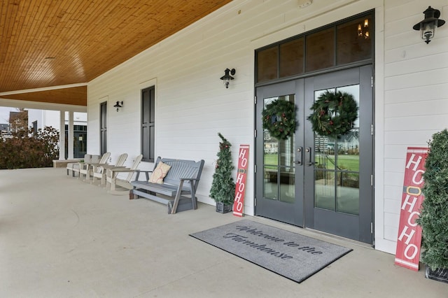 entrance to property featuring french doors and a porch