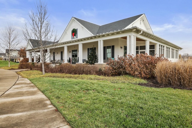 view of side of home featuring a lawn and a porch