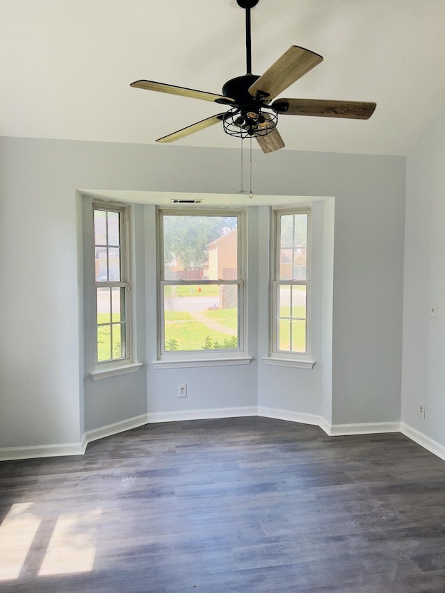 unfurnished room with vaulted ceiling, ceiling fan, and dark hardwood / wood-style floors